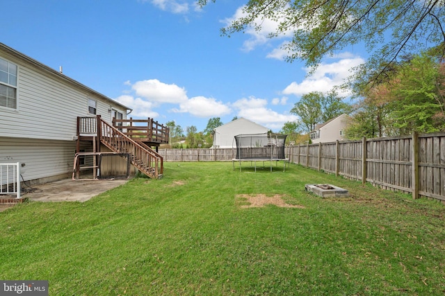 6011 Bauman Dr, Elkridge, MD 21075 - view of yard featuring a fenced backyard, a trampoline, a patio area, stairs, and a deck