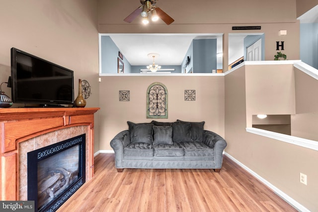 6011 Bauman Dr, Elkridge, MD 21075 - interior space with baseboards, a ceiling fan, wood finished floors, and a tiled fireplace