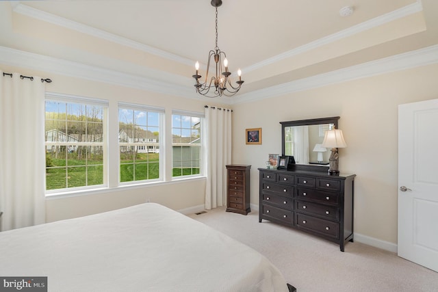 bedroom featuring a raised ceiling, carpet flooring, a notable chandelier, and ornamental molding