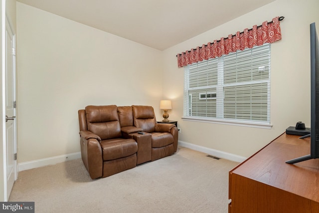 sitting room with carpet, visible vents, and baseboards