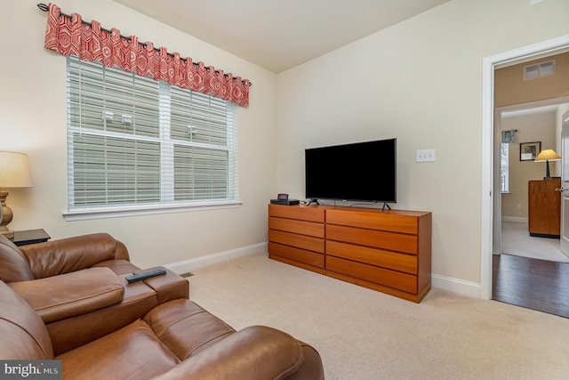 living room with baseboards, visible vents, and carpet floors