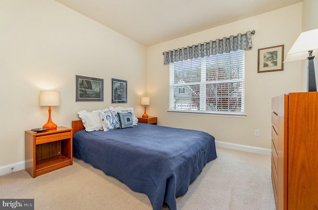 carpeted bedroom featuring baseboards
