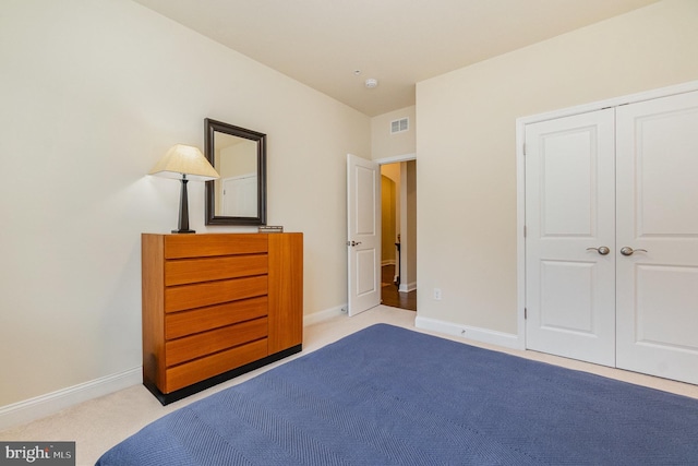 unfurnished bedroom with a closet, carpet, visible vents, and baseboards