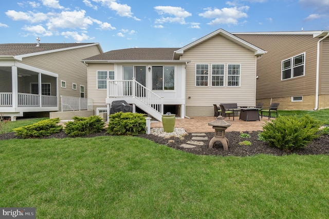 back of house with a patio area, a fire pit, a sunroom, and a yard