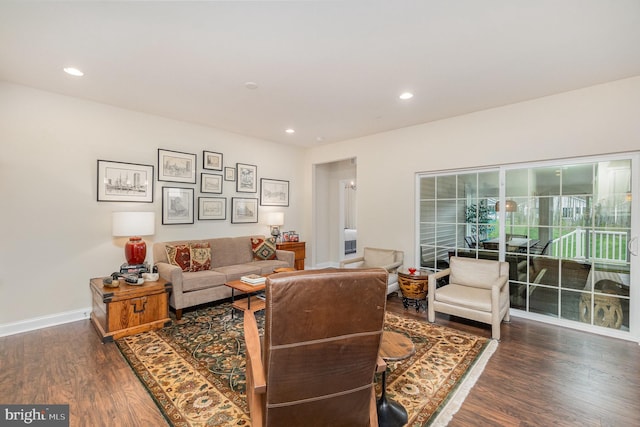 living room featuring baseboards, recessed lighting, and wood finished floors