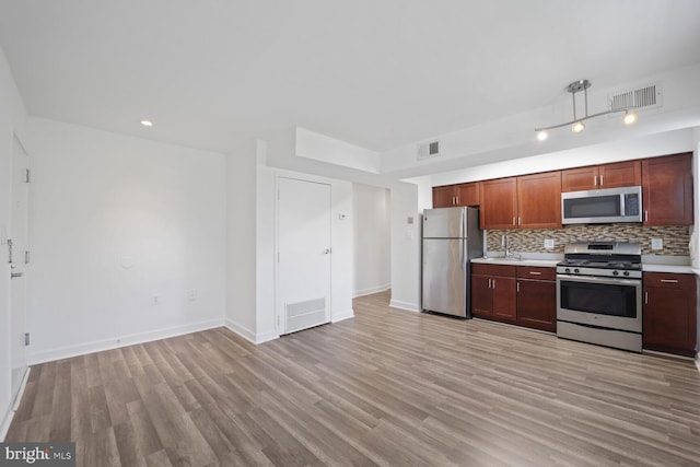 kitchen with stainless steel appliances, light countertops, and visible vents
