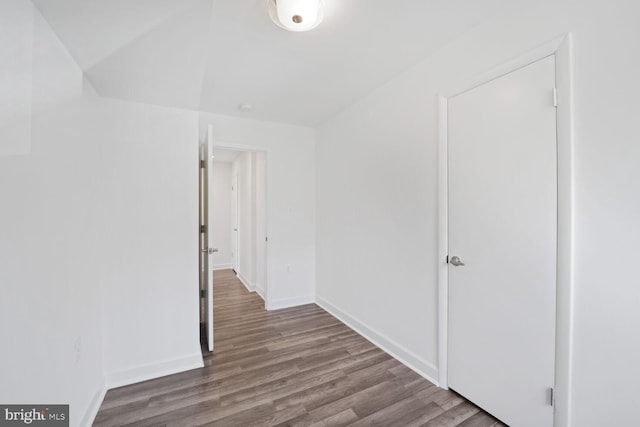 unfurnished room featuring baseboards and wood finished floors