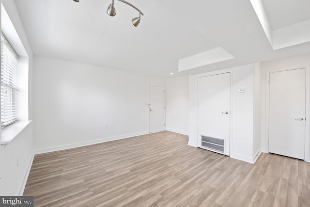 unfurnished bedroom with light wood finished floors, baseboards, and visible vents
