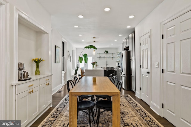 dining room with recessed lighting and dark wood finished floors