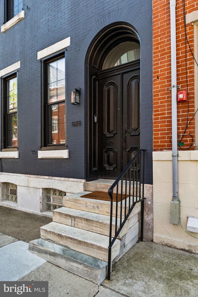entrance to property with brick siding