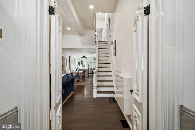 foyer entrance with recessed lighting, stairs, and dark wood-type flooring