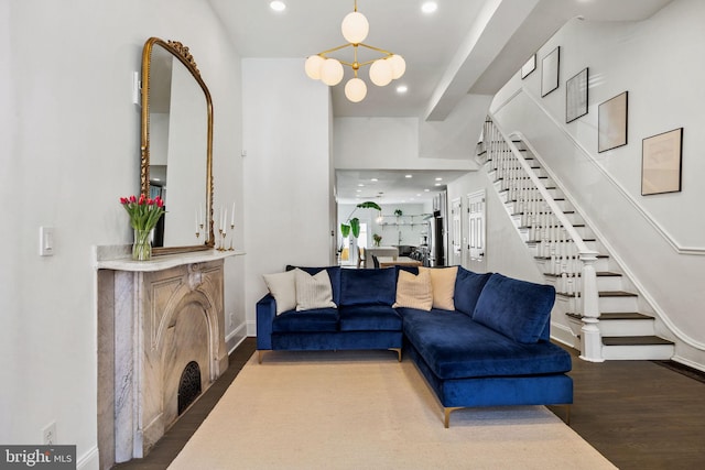 living room with recessed lighting, wood finished floors, stairs, a chandelier, and baseboards