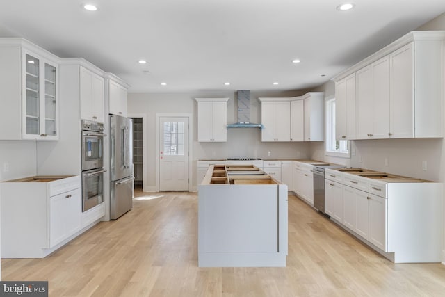 17 Hickory Ln, Malvern, PA 19355 - kitchen featuring a wealth of natural light, a center island, wall chimney exhaust hood, and stainless steel appliances