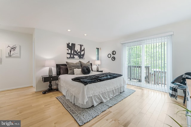 bedroom featuring recessed lighting, access to exterior, wood finished floors, and baseboards