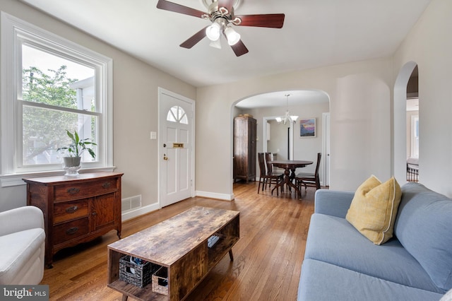 3809 13th St S, Arlington, VA 22204 - living room with arched walkways, visible vents, wood finished floors, and ceiling fan with notable chandelier