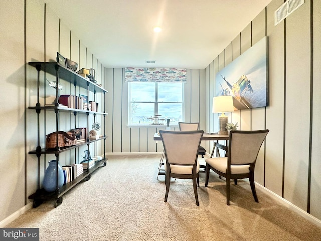 sitting room with carpet flooring, visible vents, and baseboards