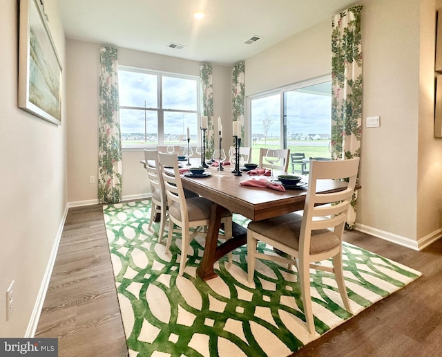 dining space featuring visible vents, baseboards, and light wood-type flooring