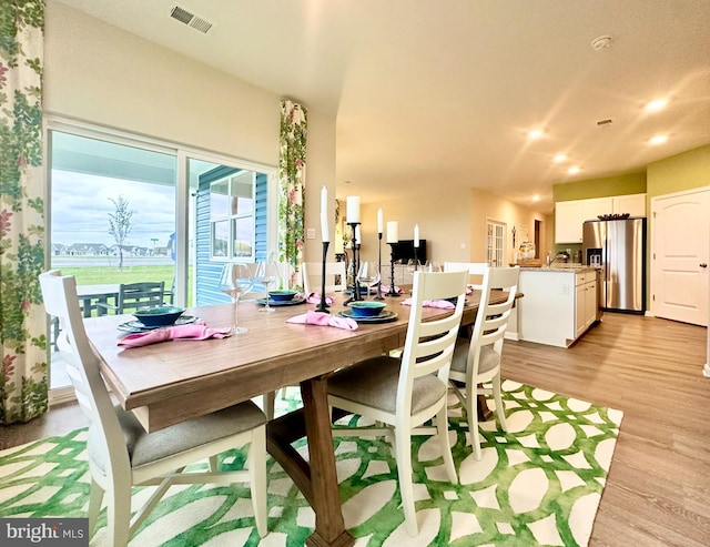 dining room featuring recessed lighting, light wood finished floors, and visible vents