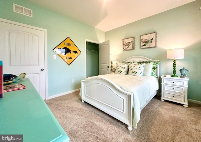 carpeted bedroom with a closet, baseboards, and visible vents
