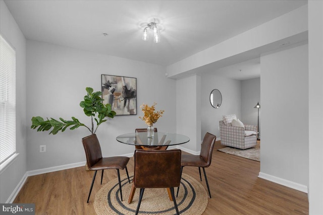 dining space with wood finished floors, baseboards, and a wealth of natural light
