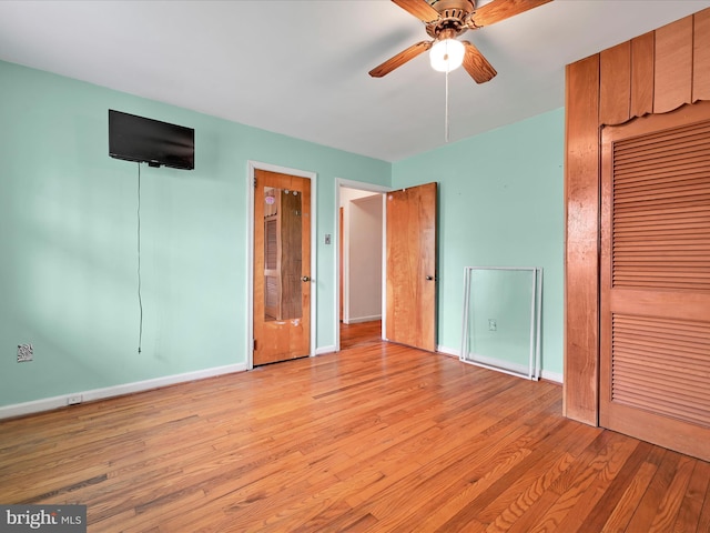 unfurnished bedroom with baseboards, light wood finished floors, and ceiling fan