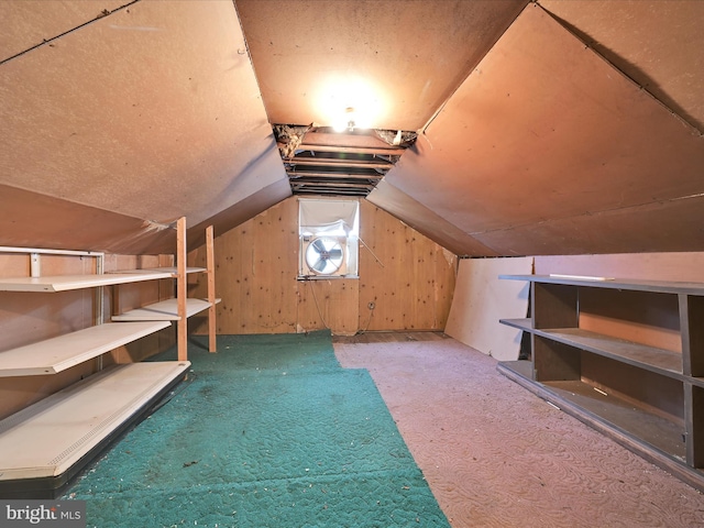 bonus room with vaulted ceiling and carpet floors