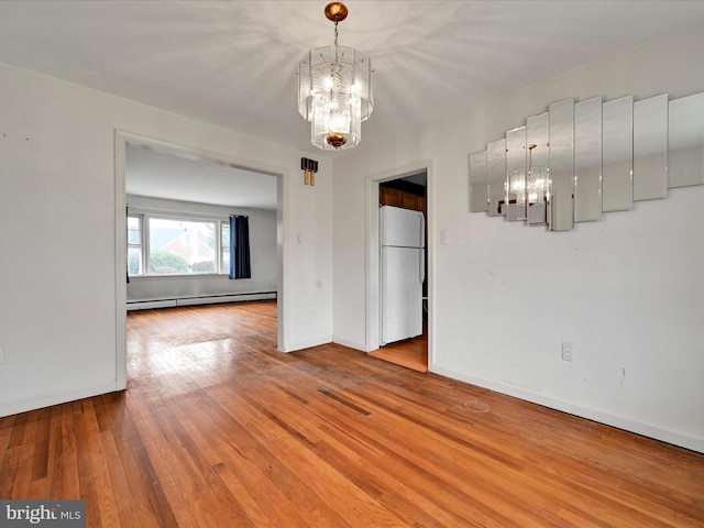 unfurnished dining area with hardwood / wood-style flooring, baseboard heating, baseboards, and an inviting chandelier