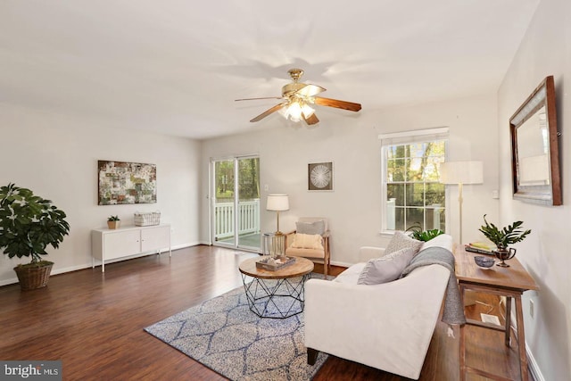 living area with a healthy amount of sunlight, a ceiling fan, and wood finished floors