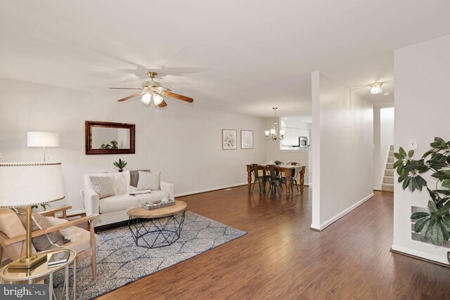 935 Forest Hills Ave, Annapolis, MD 21403 - living area with stairway, baseboards, ceiling fan with notable chandelier, and wood finished floors
