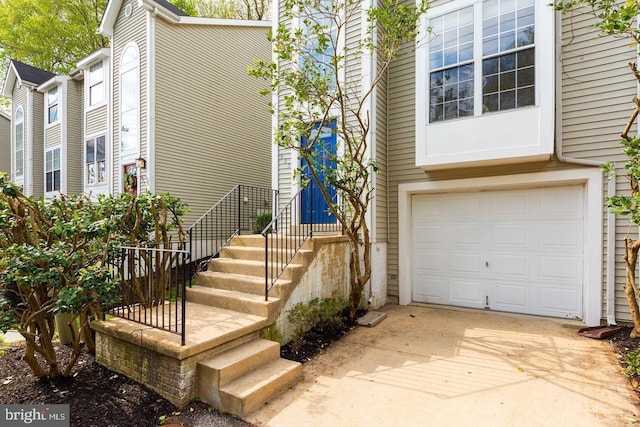 property entrance with a garage and driveway