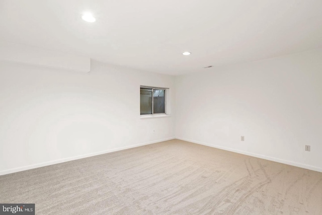 unfurnished room featuring recessed lighting, baseboards, and carpet