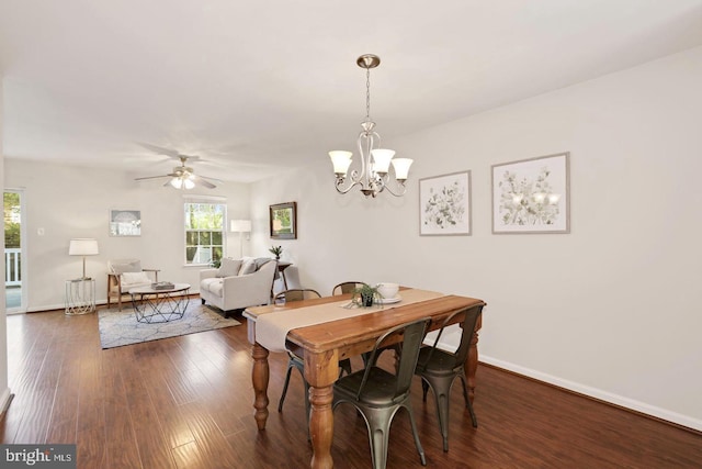dining room featuring a healthy amount of sunlight, baseboards, and dark wood-style floors