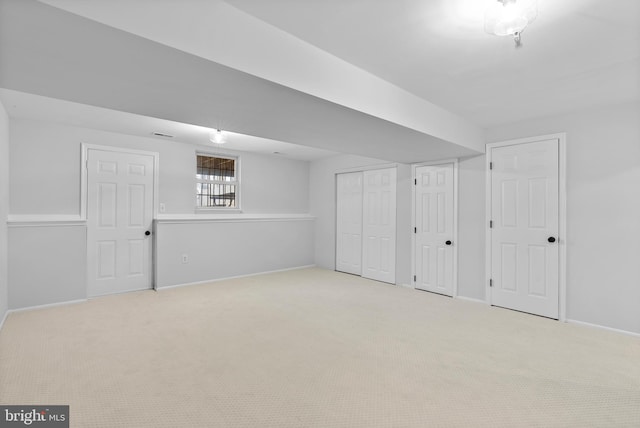 below grade area with baseboards and carpet
