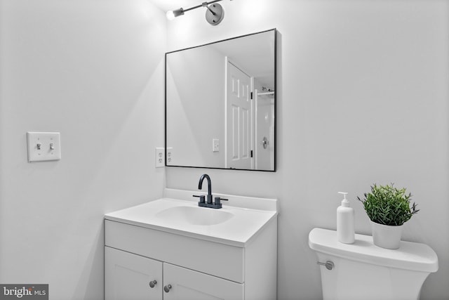 half bathroom featuring toilet and vanity