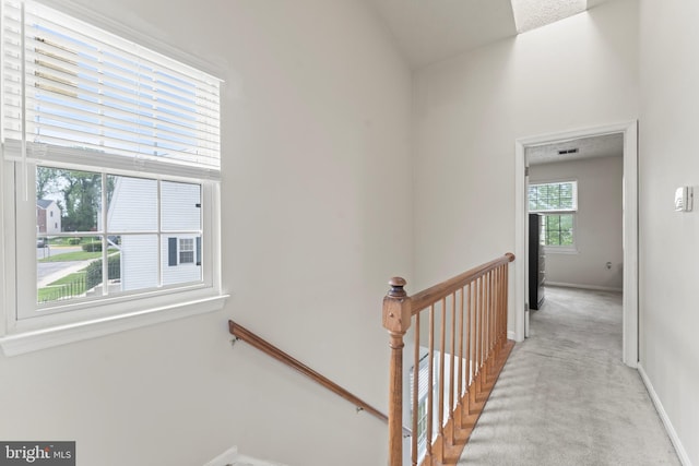 10633 Campus Way S, Upper Marlboro, MD 20774 - hallway featuring visible vents, baseboards, light carpet, and an upstairs landing