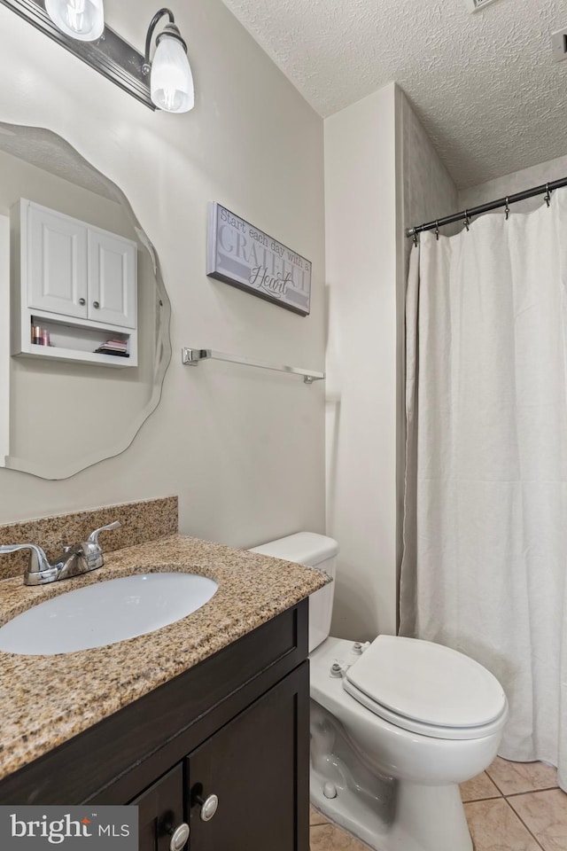 10633 Campus Way S, Upper Marlboro, MD 20774 - bathroom featuring a textured ceiling, vanity, curtained shower, toilet, and tile patterned flooring