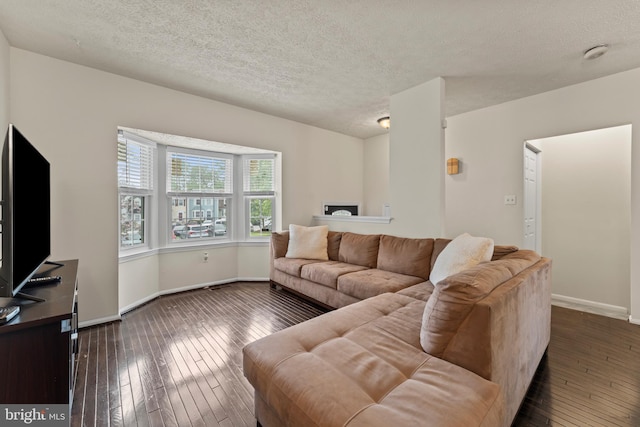 10633 Campus Way S, Upper Marlboro, MD 20774 - living room featuring baseboards, a textured ceiling, and dark wood-type flooring