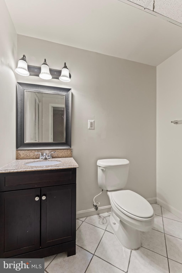 10633 Campus Way S, Upper Marlboro, MD 20774 - bathroom with baseboards, tile patterned flooring, vanity, and toilet