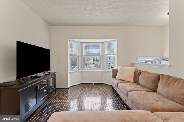 10633 Campus Way S, Upper Marlboro, MD 20774 - living room featuring baseboards, a textured ceiling, and dark wood-type flooring