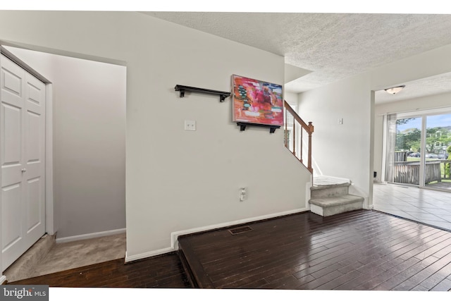 10633 Campus Way S, Upper Marlboro, MD 20774 - interior space featuring hardwood / wood-style flooring, baseboards, a textured ceiling, and stairway