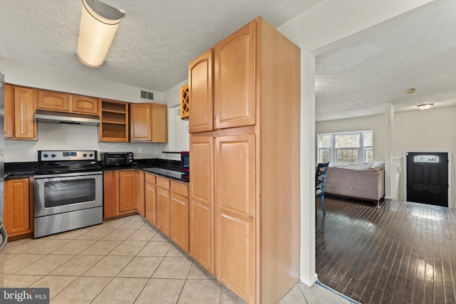 10633 Campus Way S, Upper Marlboro, MD 20774 - kitchen featuring dark countertops, a textured ceiling, stainless steel electric range oven, under cabinet range hood, and visible vents
