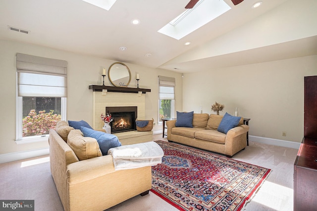 living room with a skylight, carpet flooring, a fireplace, recessed lighting, and lofted ceiling