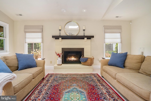 living area with a fireplace and baseboards