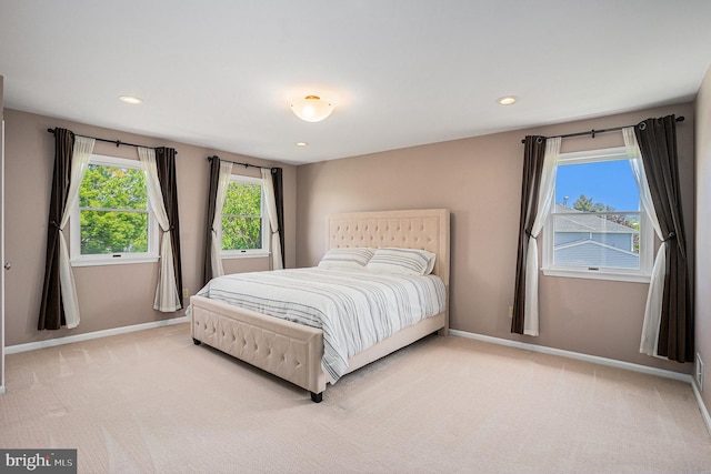 bedroom featuring baseboards, light colored carpet, and recessed lighting