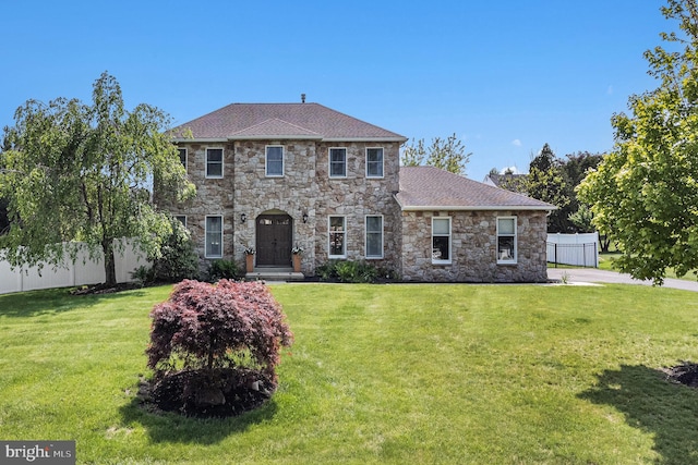 colonial house with stone siding and roof with shingles