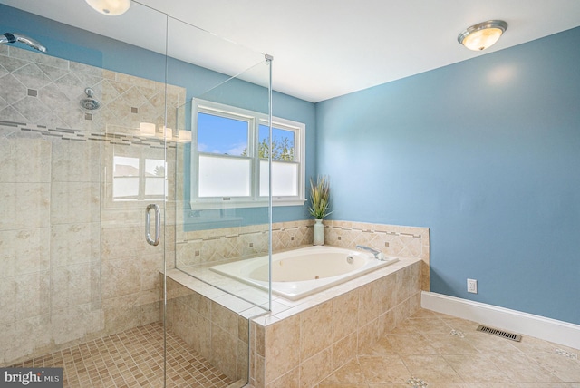 full bath with tile patterned flooring, a shower stall, a garden tub, and baseboards