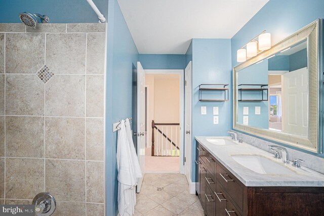 full bath with tile patterned floors, double vanity, and a shower