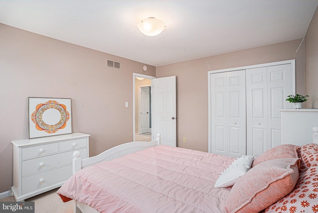 carpeted bedroom featuring a closet and baseboards