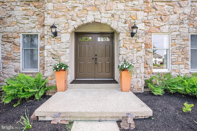 doorway to property with stone siding