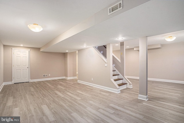 finished basement featuring wood finished floors, baseboards, stairs, and recessed lighting